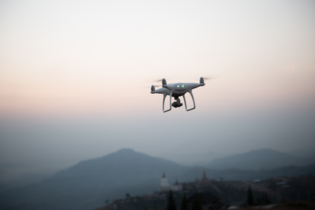 Drone flying on a mountain view at beautiful twilight sky. Vehicle at sundown and copy space.の写真素材