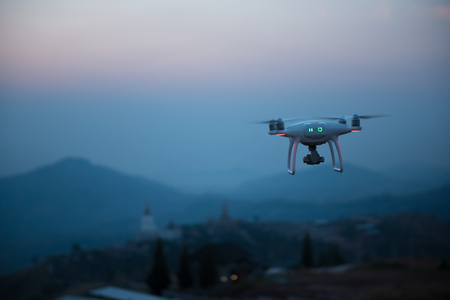 Drone flying on a mountain view at beautiful twilight sky. Vehicle at sundown and copy space.の写真素材