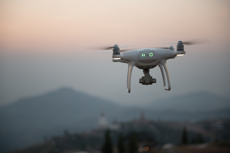 Drone flying on a mountain view at beautiful twilight sky. Vehicle at sundown and copy space.の写真素材