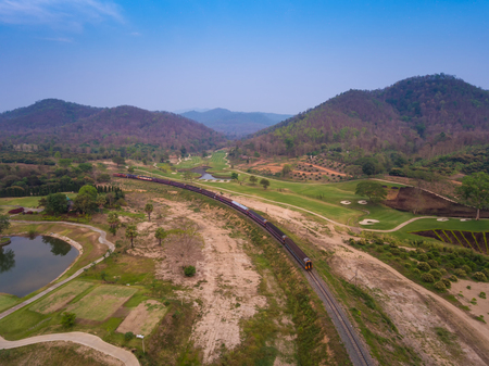 Aerial view train is running through the golf course. There are beautiful bridges in Thailand.の写真素材