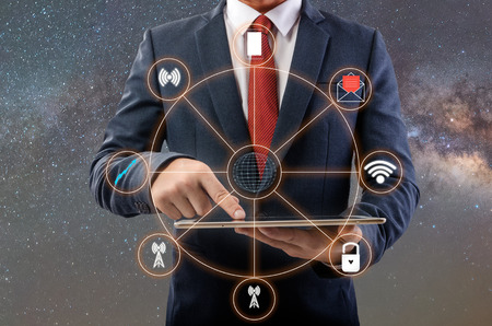 businessman and a using a tablet Laptop on table.Milkyway  backgroundの写真素材