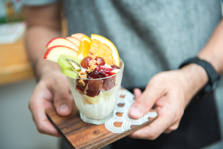 Closeup of Man hands holding cup  frozen yogurt Ice creamの写真素材