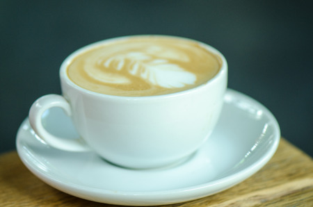coffee latte art on wooden backgroundの写真素材