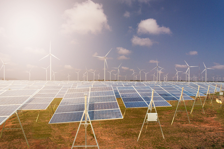 Beautiful Solar panels with wind turbines landscape blue sky with clouds and (solar cell) in solar farm with sun lighting to create the clean electric power Concept.の写真素材
