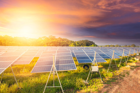 Beautiful sunset over  Solar energy at Solar panels (solar cell) in solar farm with sun lighting to create the clean electric powerの写真素材