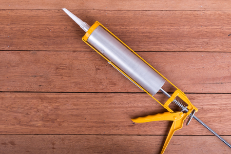 Silicone gun on wooden floors.の写真素材