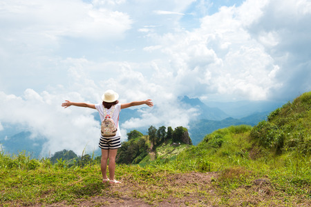 Woman Enjoying Nature on grass meadow on top of mountain in Thailandの写真素材