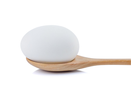 white egg in the spoon on white backgroundの写真素材