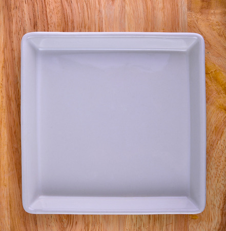 white plate on woodの写真素材