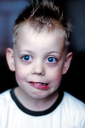 Child with big blue eyes in a T-shirtの写真素材