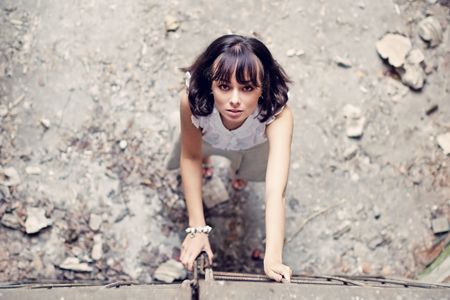 Pretty young woman standing against the gates の写真素材