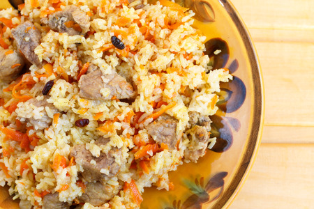 pilaf with meat on wooden deskの写真素材
