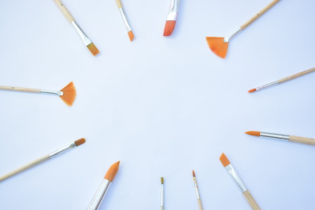 artists paint brushes arranged in a circle giving space for centred contentの写真素材