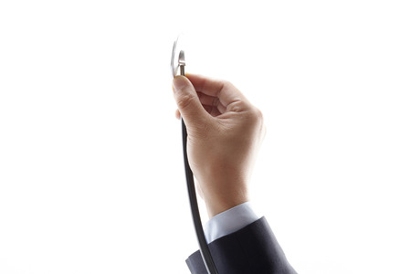 hand holding a stethoscope isolated on white backgroundの写真素材
