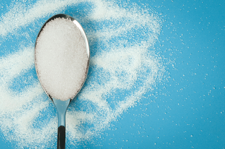 Sugar spoon blue background.の写真素材