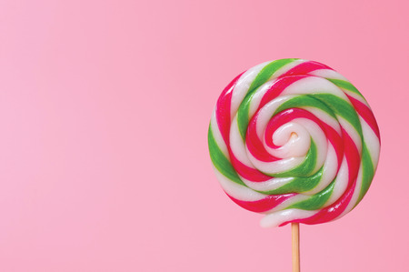 Colorful candy lollipops round pink background.の写真素材