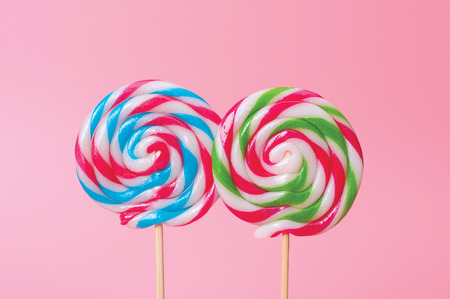 Colorful candy lollipops round pink background.の写真素材
