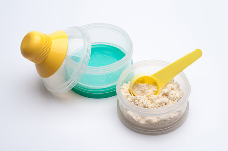 Container of powdered milk for infants on white background.の写真素材