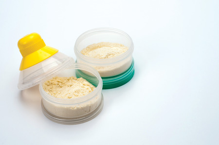 Container of powdered milk for infants on white background.の写真素材