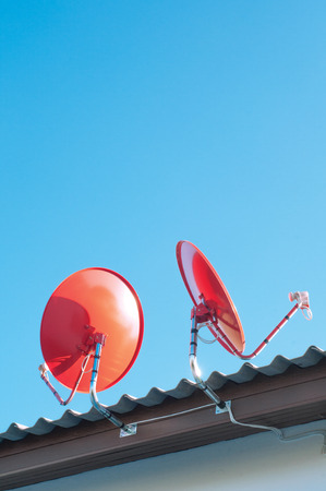 Satellite dish transmission data on background blue sky.の写真素材
