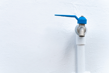 Tap closeup with dripping water-drop. Water leaking, saving concept.の写真素材