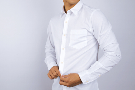 A man wearing a white shirt. White background.の写真素材