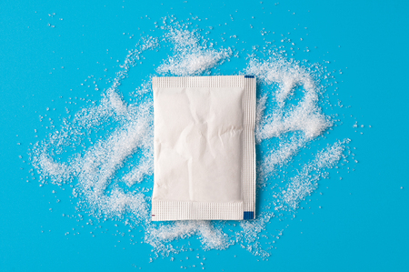 White Sugar Packets on a Blue background.の写真素材