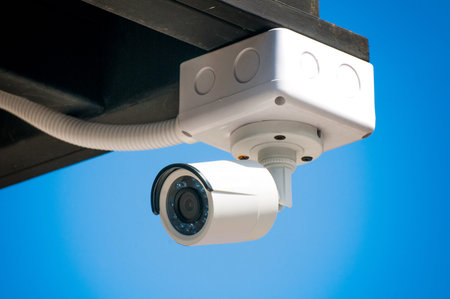 CCTV security cameras outside the white building.