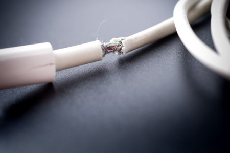 Closeup the Broken Smart Phone Charger Cable on black Background.