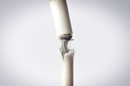 Closeup the Broken Smart Phone Charger Cable on white Background.の写真素材