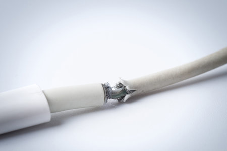 Closeup the Broken Smart Phone Charger Cable on white Background.
