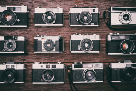 BANGKOK,THAILAND - JUNE 19,2017 : Retro film cameras on wooden background.