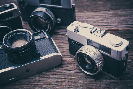 BANGKOK, THAILAND - JUNE 19 2017 : Retro film cameras on wooden background.のeditorial素材