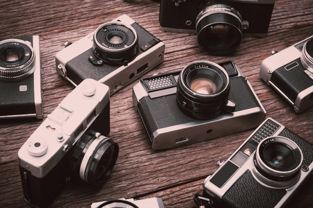 BANGKOK,THAILAND - JUNE 19,2017 : Retro film cameras on wooden background.のeditorial素材