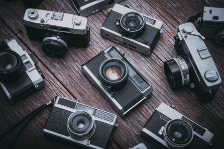 BANGKOK,THAILAND - JUNE 19,2017 : Retro film cameras on wooden background.のeditorial素材