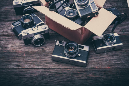BANGKOK,THAILAND - JUNE 19,2017 : Retro film cameras on wooden background.のeditorial素材