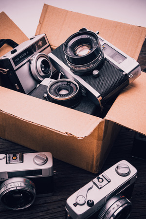 BANGKOK,THAILAND - JUNE 19,2017 : Retro film cameras on wooden background.のeditorial素材