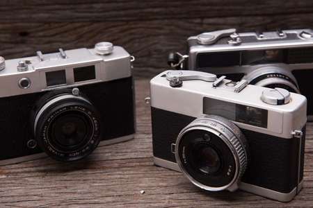 BANGKOK,THAILAND - JUNE 19,2017 : Retro film cameras on wooden background.のeditorial素材