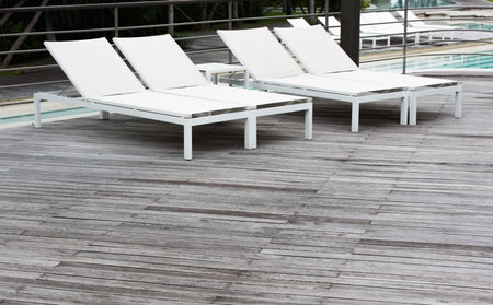 Wooden floor, swimming pool and white pool bed.