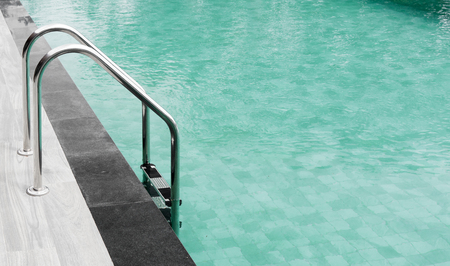 Swimming pool with stairs and wooden floor.の写真素材