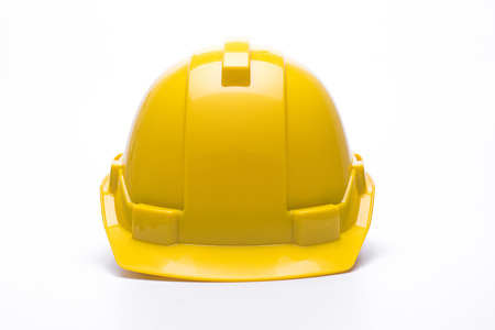 Yellow safety helmet isolated on white backgroundの写真素材
