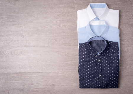 New man's shirt on wood backgroundの写真素材