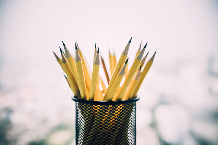 yellow sharp pencil in black metal basket.の写真素材
