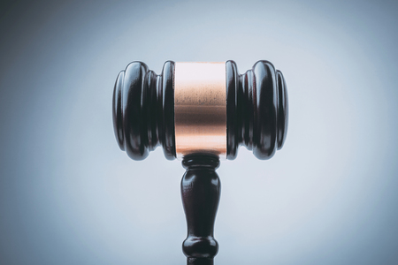 Black Judge Wood Hammer with blue background.の写真素材