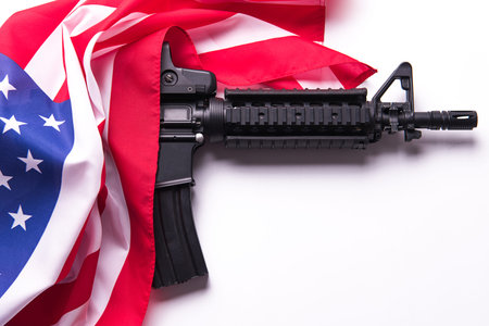 American flag with gun on white background.の写真素材