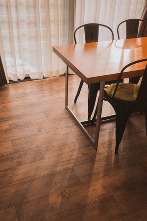 Dining table in the Cozy room on wooden floorの写真素材