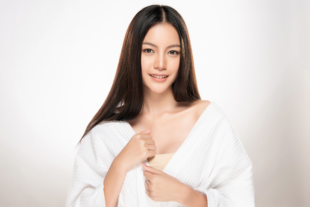 Beautiful smiling woman with clean skin, natural make-up, and white teeth on white backgroundの写真素材