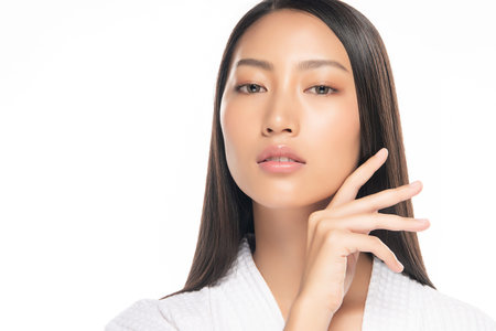 Beautiful Young Asian Woman with Clean Fresh Skin. Face care, Facial treatment, on white background,...