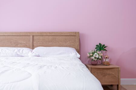 bedroom Interior of room with comfortable bed near pink wallの写真素材