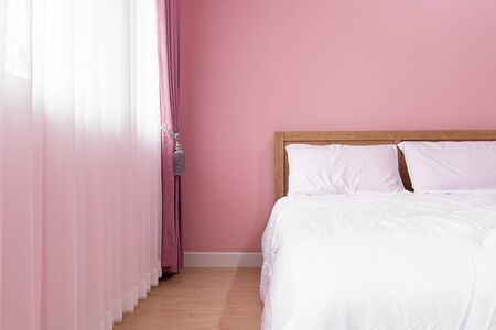 bedroom Interior of room with comfortable bed near pink wallの写真素材